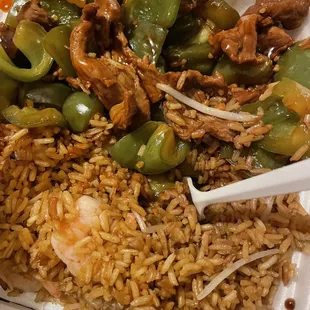 a plate of rice with meat and vegetables