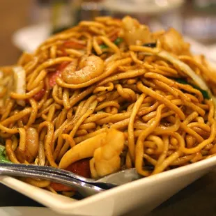 a bowl of noodles and chopsticks