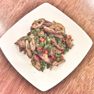 a plate of stir fried meat and vegetables