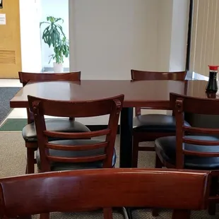 a dining room with a table and chairs