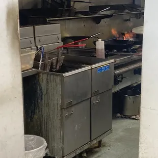 Filth! Piles of debris around the fryer and stove.