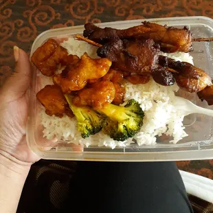 a person holding a plastic container of food