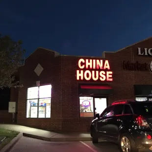 a car parked in front of a chinese restaurant