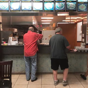 two men standing at the counter
