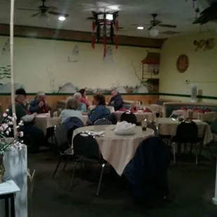 people sitting at tables in a chinese restaurant