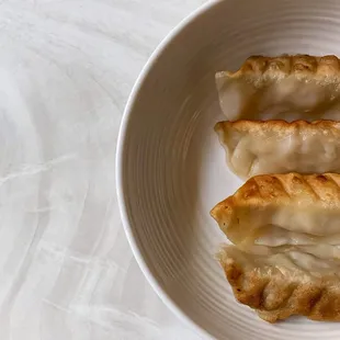 two dumplings on a white plate