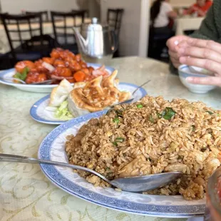 a plate of fried rice and a bowl of salad