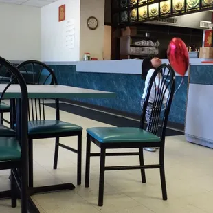 a little girl sitting at a table