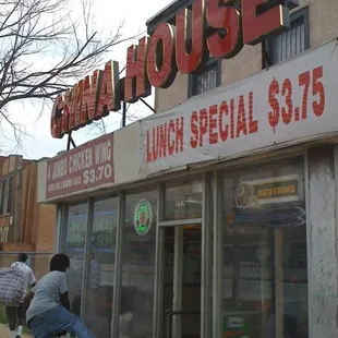 a man riding a bicycle in front of a restaurant