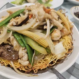 a plate of noodles with meat and vegetables