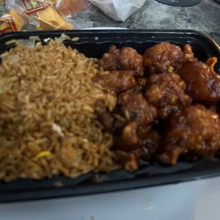 a tray of food with rice and meat