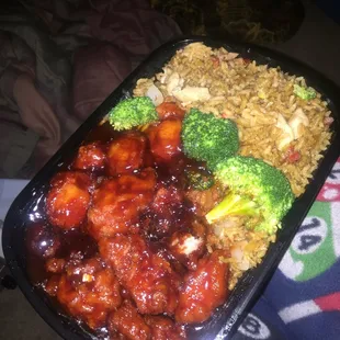 a tray of food with rice, broccoli, and meat