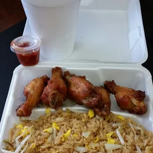 chicken wings and rice in a styrofoam container