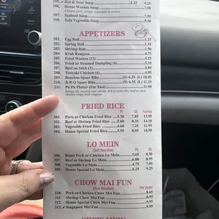 a person holding a menu in a car