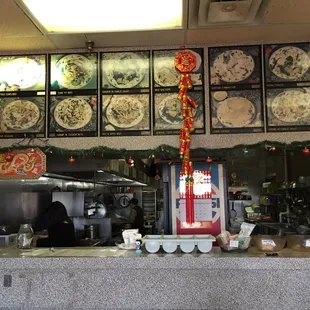 a restaurant counter with plates on the wall