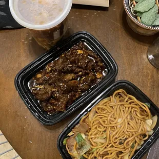 two take out containers of food on a table