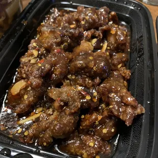 a tray of meat with sauce