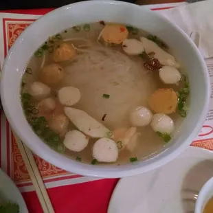 Seafood noodle soup with egg roll