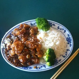 a plate of food with rice and broccoli