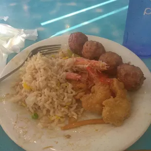 a plate of food with rice and meat