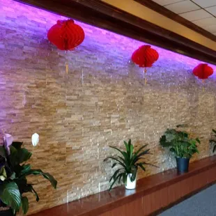 a row of planters in front of a stone wall