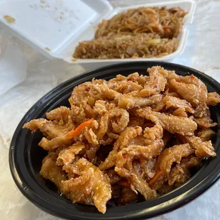 a bowl of noodles and a plate of meat