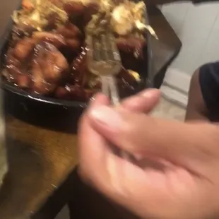 a person taking a picture of a plate of food