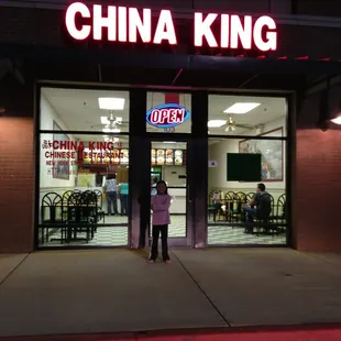 a woman standing in front of a restaurant