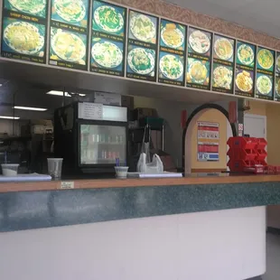 the counter and menus of a chinese restaurant