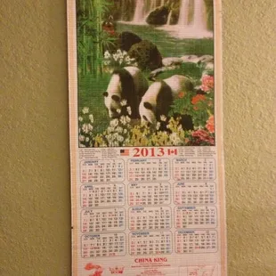 two pandas in front of a waterfall