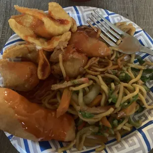 a plate of noodles, meat and vegetables