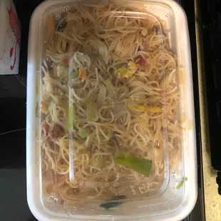 a container of noodles and vegetables
