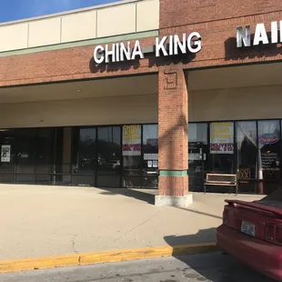 a red car parked in front of the store
