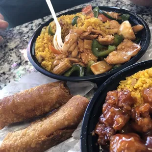 a plate of chicken, rice, and vegetables