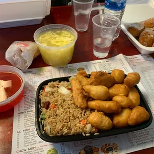 D12. Sweet and Sour Chicken Combination Plate with 27. Egg Fried Rice and 1. Egg Roll, 18. Egg Drop Soup, and wontons 13. Chinese Donuts