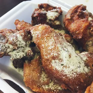 fried chicken wings in a styrofoam container