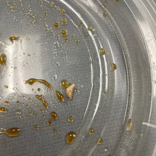 a mixture of oil and vinegar in a plastic container