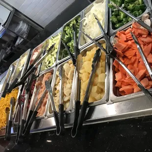 a variety of salads in a buffet