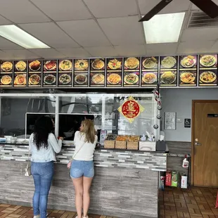 two women standing in front of a counter