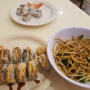a plate of sushi and a bowl of noodles