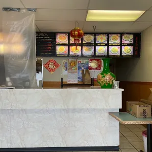a restaurant counter with a man in a chef's hat