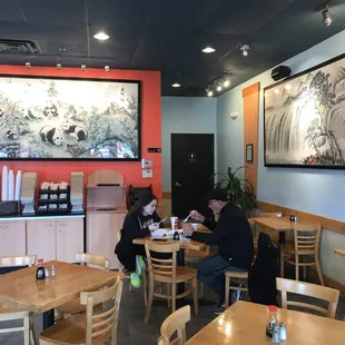 a man and a woman eating in a restaurant