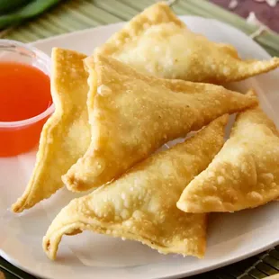 a plate of fried food with dipping sauce