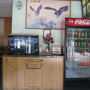 a chinese restaurant with a large painting on the wall