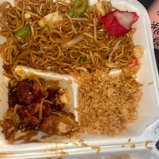 a plate of noodles, meat, and vegetables