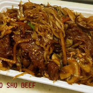 a plate of noodles and meat