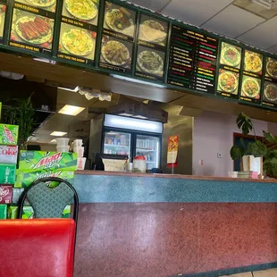 the counter and menus of a chinese restaurant