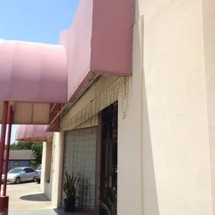 he outside of a building with a pink awning