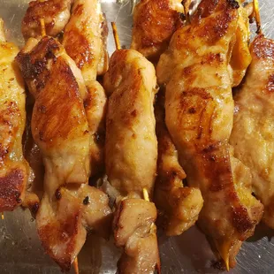 chicken skewers on a metal tray