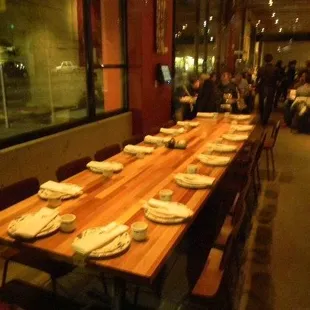 a long wooden table with plates on it